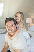 Father and daughter hugging on bed