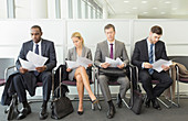 Business people reading in waiting area