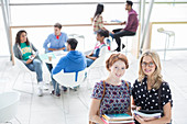 University students smiling in lounge