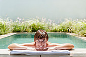 Woman relaxing in luxury lap pool