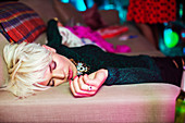 Woman sleeping on sofa at party