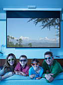 Family watching 3D television