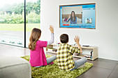 Children video chatting on television