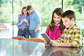 Family using technology in kitchen