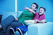 Father and son watching television