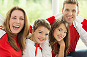 Family in sports jerseys cheering