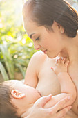 Mother breast-feeding baby boy