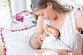 Mother breast-feeding baby boy