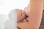 Mother breast-feeding baby girl