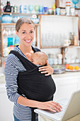 Mother with baby boy using laptop