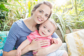 Mother holding baby boy outdoors