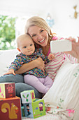 Mother taking self-portrait with baby