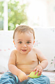 Baby boy sitting on sofa