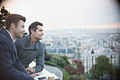 Businessmen overlooking cityscape, Paris