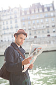 Businessman reading newspaper in Paris