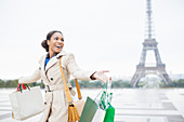 Woman carrying shopping bags, Paris