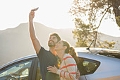 Happy couple taking self-portrait