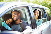 Portrait of happy family inside car