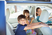 Portrait of happy family inside of car