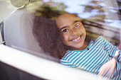 Happy girl in back seat of car