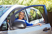 Senior woman getting out of car