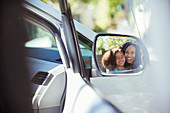 Reflection of smiling mother and daughter