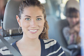 Portrait of smiling woman inside car