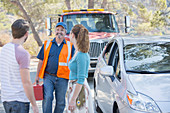 Roadside mechanic arriving to help couple