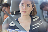 Pensive woman inside car
