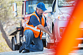 Roadside mechanic repairing flat tire