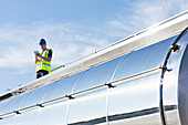 Worker using tablet on platform