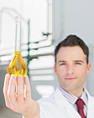 Scientist holding beaker with liquid