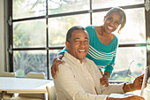 Smiling senior couple at laptop