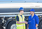 Workers with clipboard talking