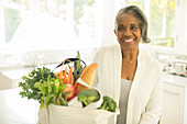 Smiling senior woman with groceries