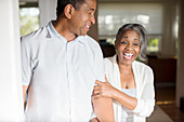 Laughing senior couple in doorway