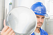 Worker holding stainless steel tube
