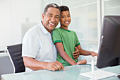 Grandfather and grandson at computer