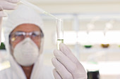 Scientist using pipette and test tube
