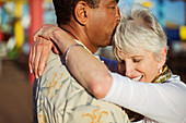 Senior couple kissing outdoors