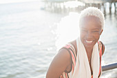 Portrait of smiling woman at oceanfront
