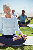 Senior woman practicing yoga in park