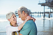 Senior couple hugging on beach