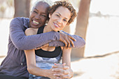 Smiling women hugging outdoors