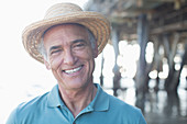 Senior man in sun hat at beach