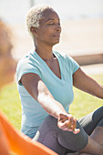 Serene woman meditating in lotus position