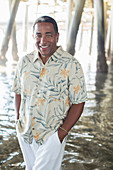 Senior man under pier at beach