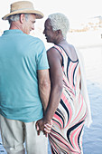 Senior couple holding hands and walking