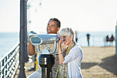 Senior couple using binoculars