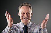 Portrait of smiling businessman gesturing